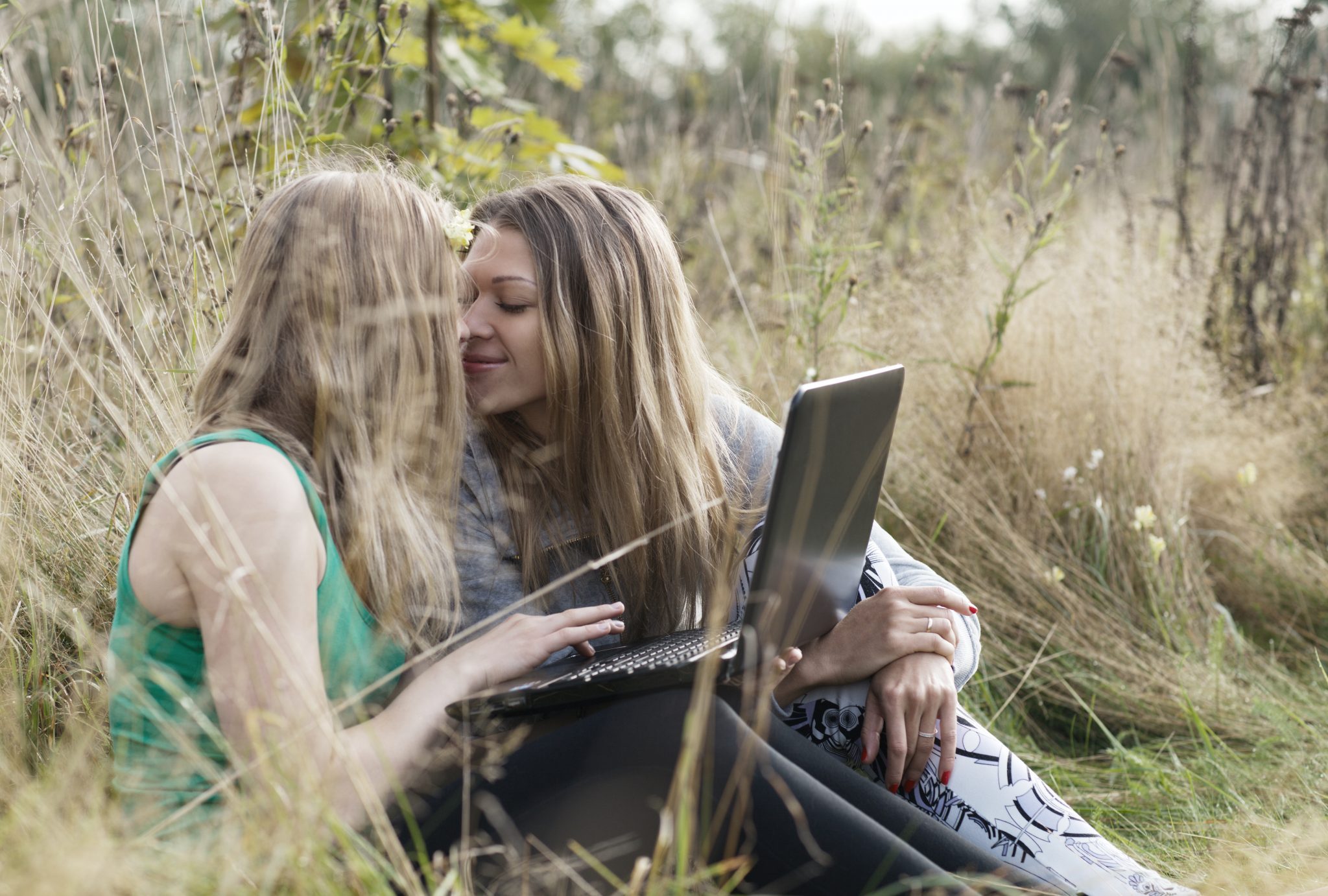 Two women friends sitting outdoors together