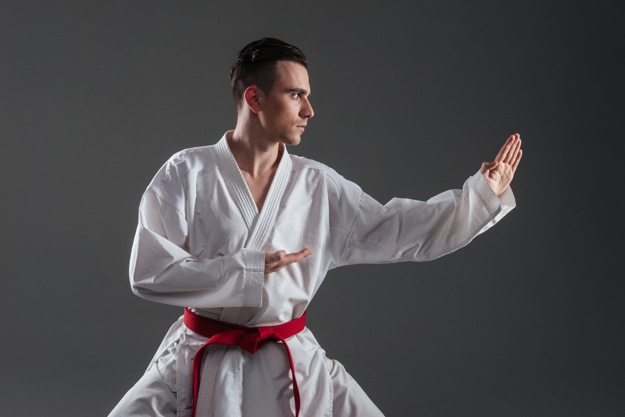 Young sportsman dressed in kimono practice in karate